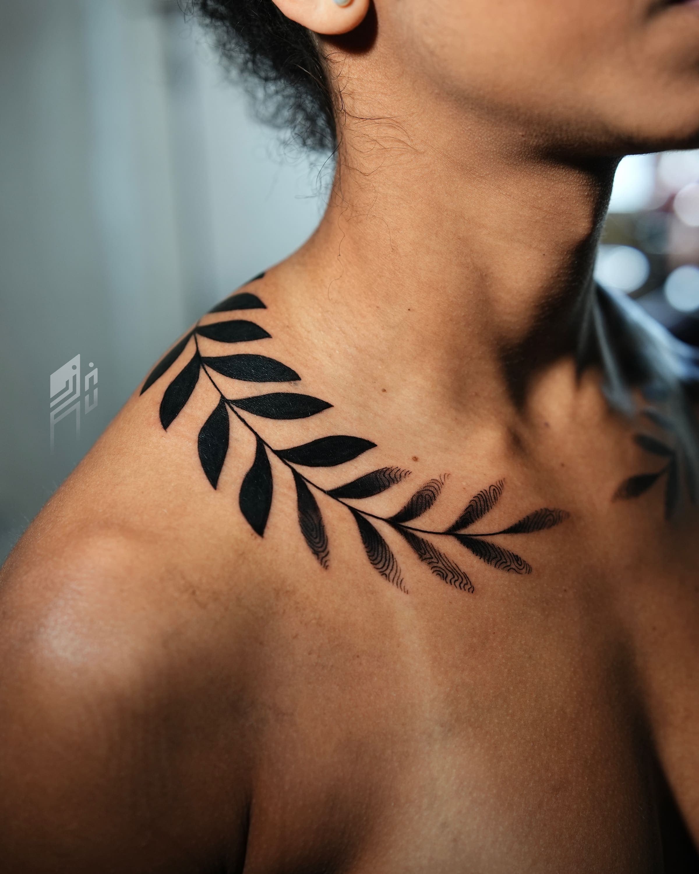 Blackwork tattoo of a leafy branch wrapping the collarbone and shoulder, by Rivas Indeed in San Juan, Puerto Rico